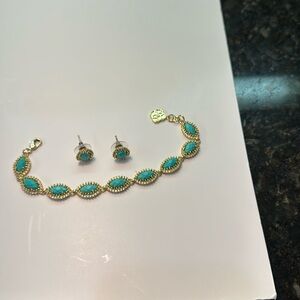 A Kendra Scott matching bracelet and earring set.